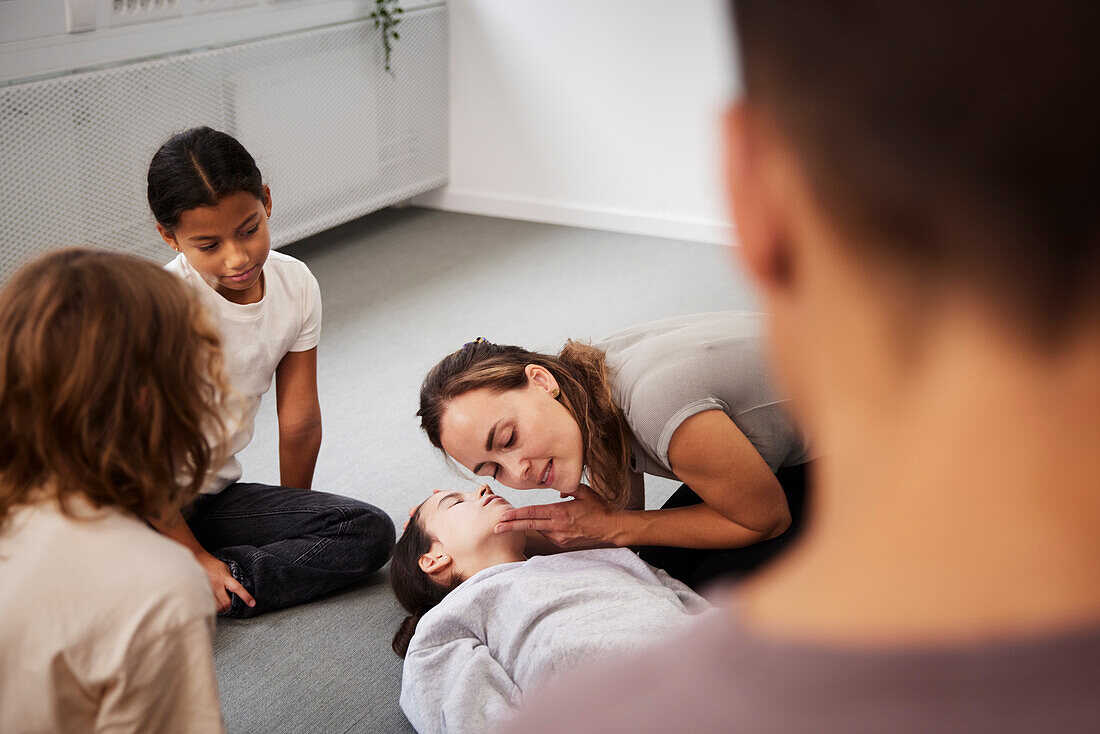 Teacher giving first aid training