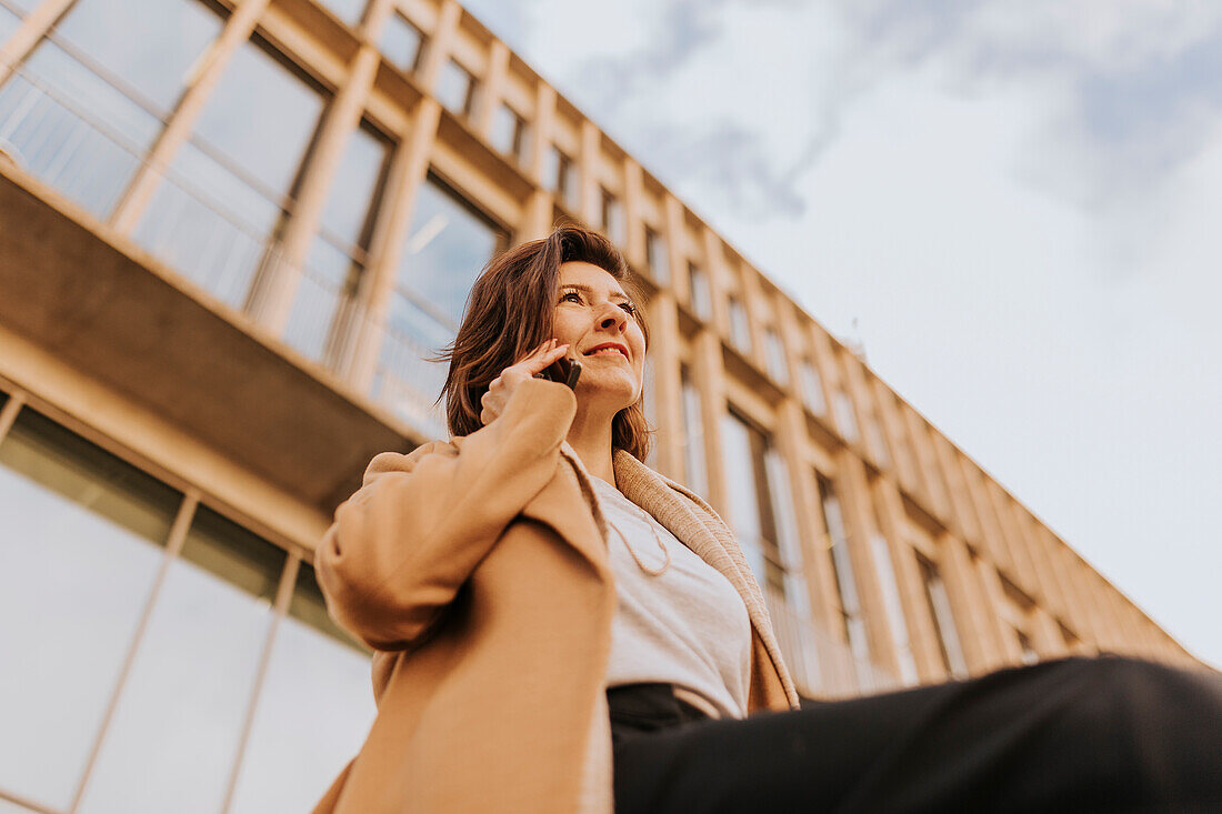 Smiling woman using cell phone