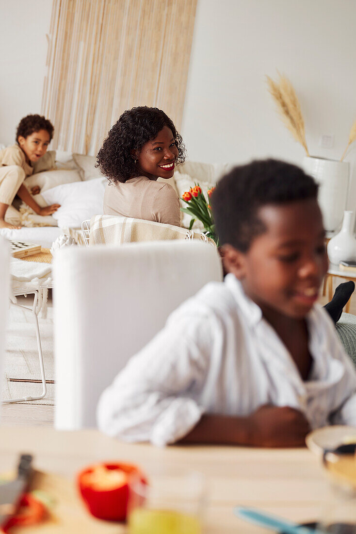 Mother working from home and smiling to son