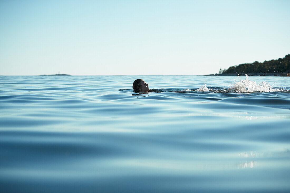 Teenage girl swimming in sea