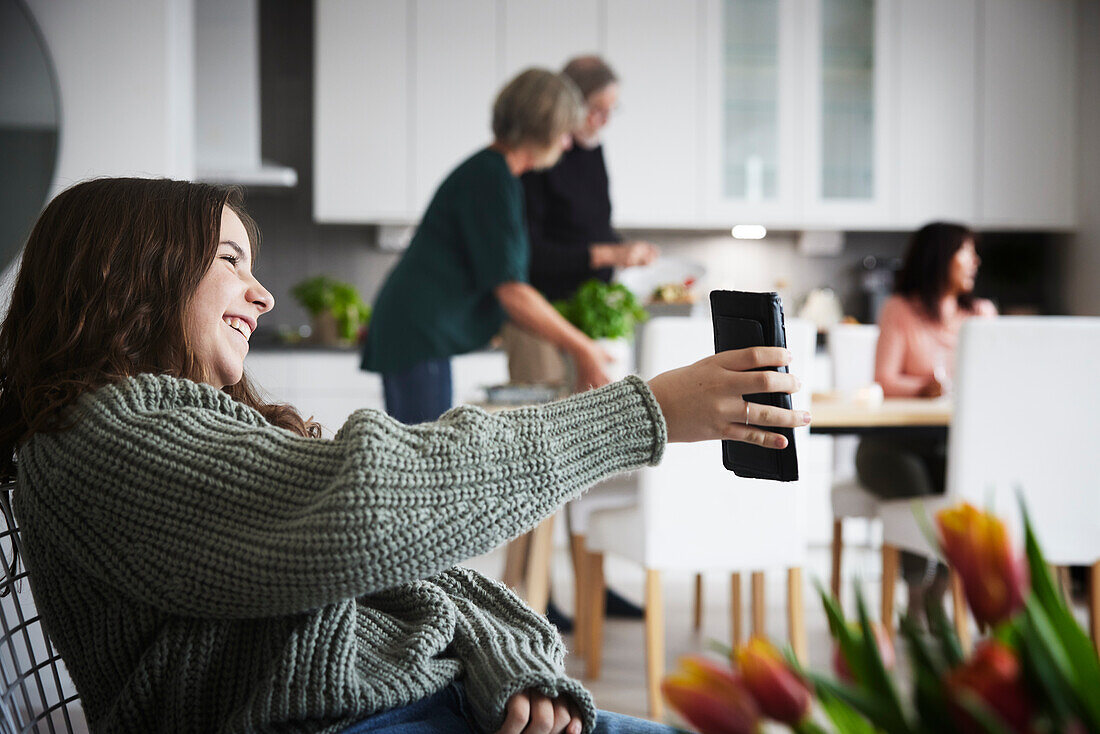 Smiling teenager girl showing phone