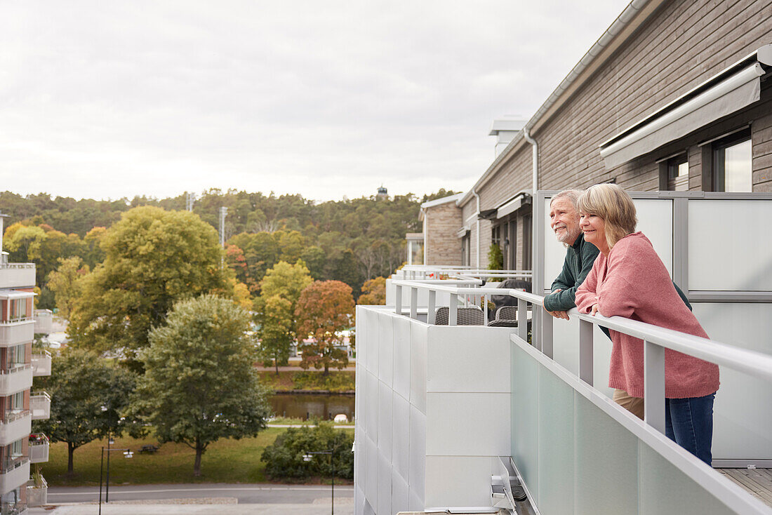Senior couple standing on balcony