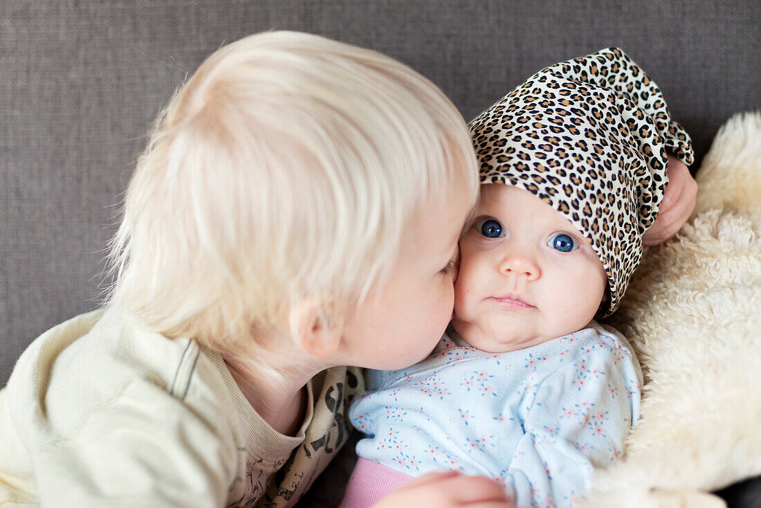 Girl kissing her baby sister