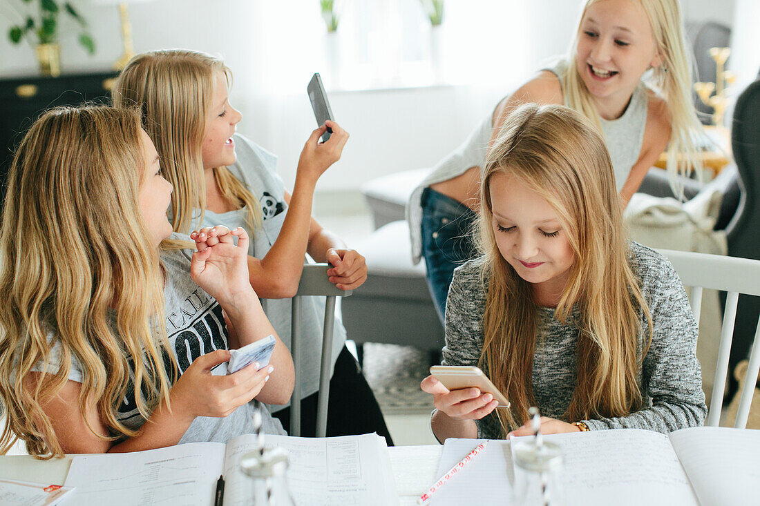 Happy girls using cell phones