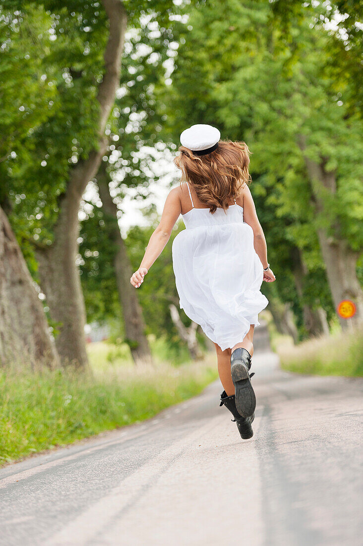 Young woman walking on road