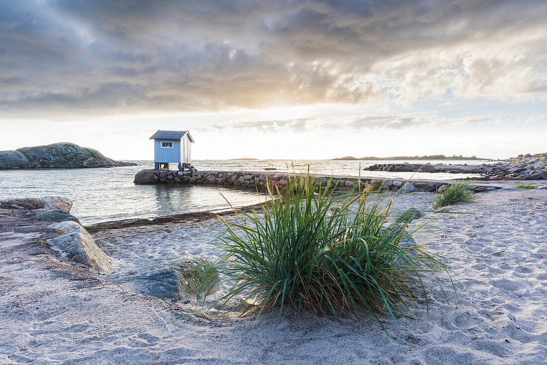 Sandy beach, wooden building on background