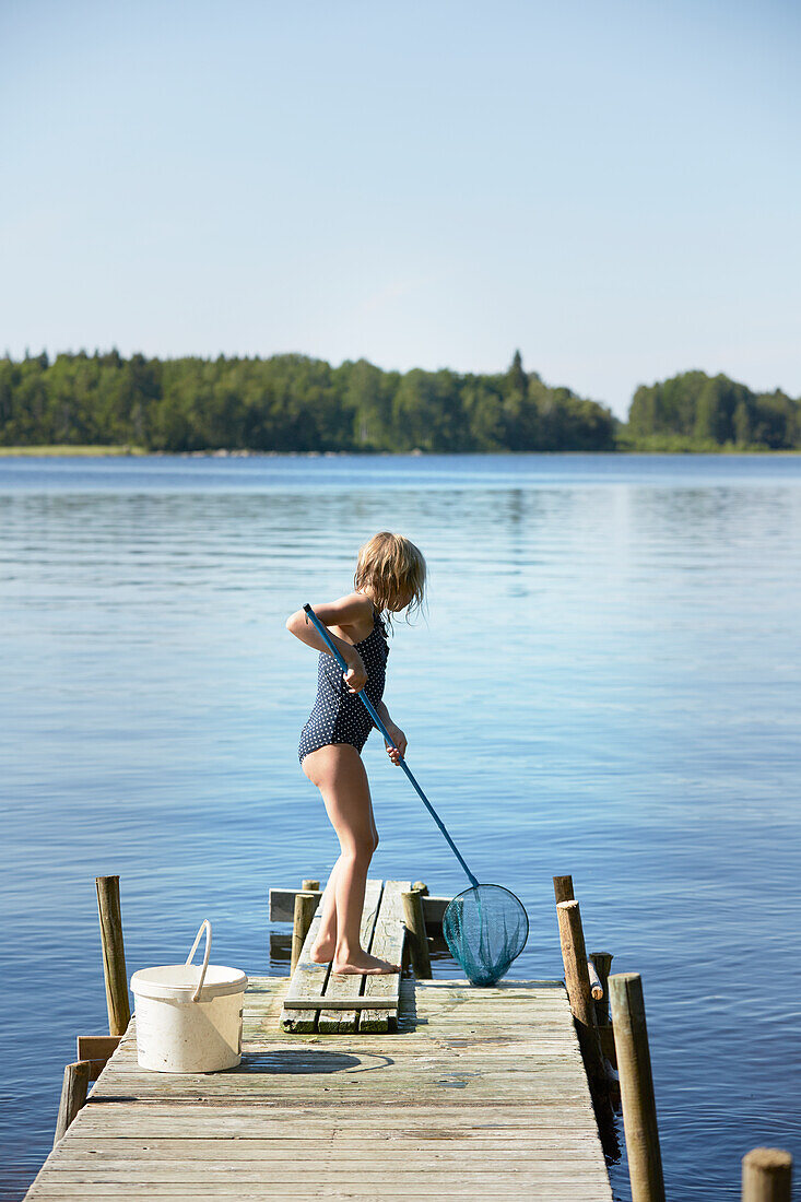 Girl fishing on jetty