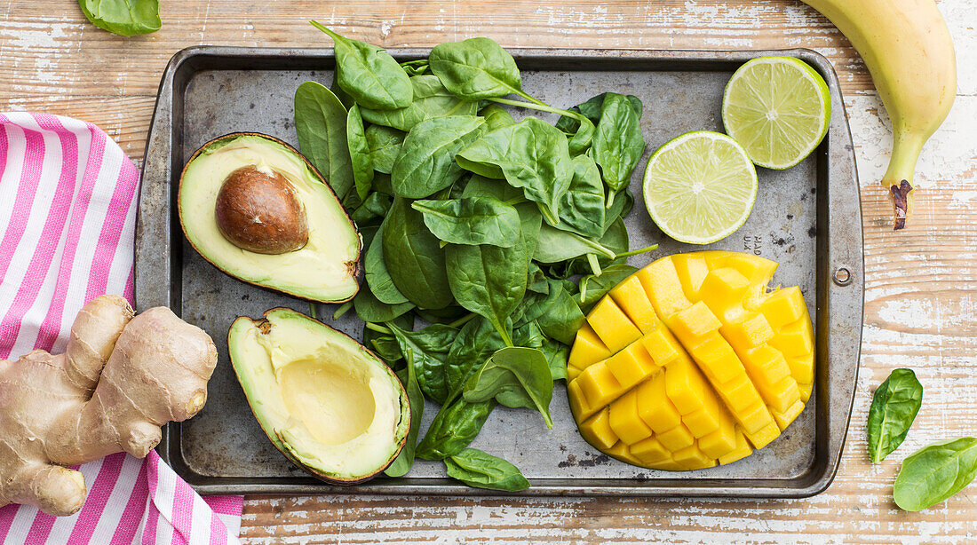 Spinach, avocado and pineapple on baking tray