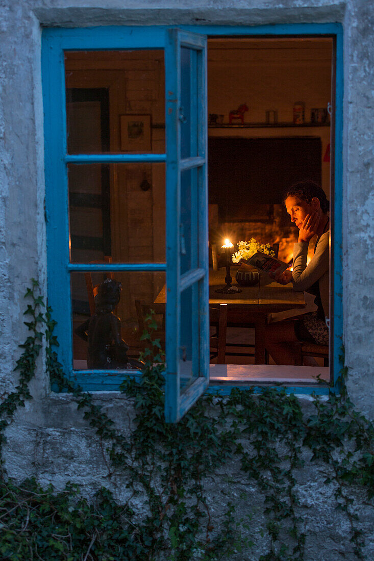 Woman reading book in evening