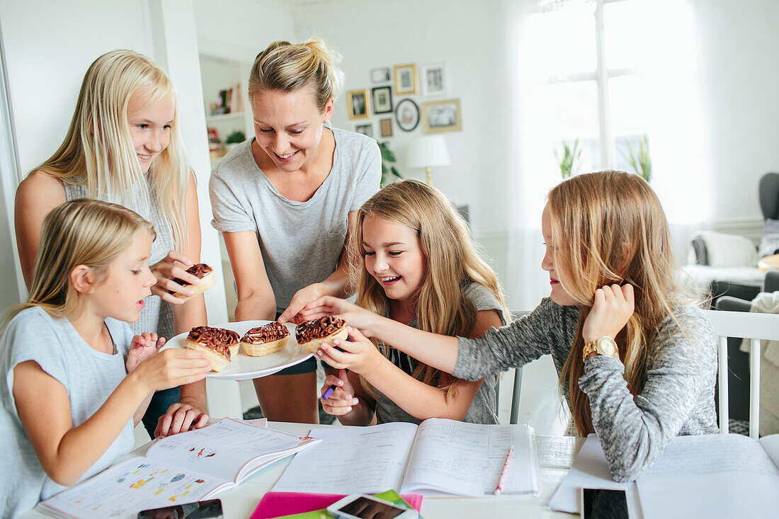 Girls having snack while they learning together