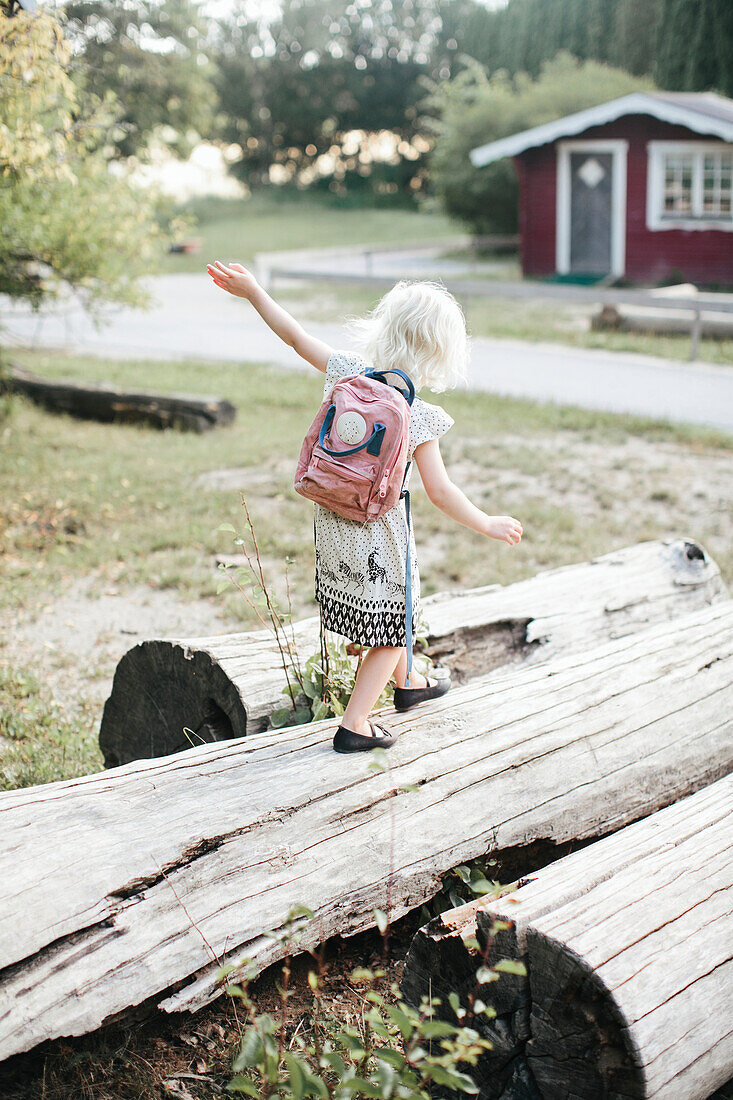 Girl walking on log