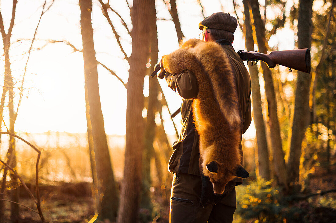 Hunter carrying fox