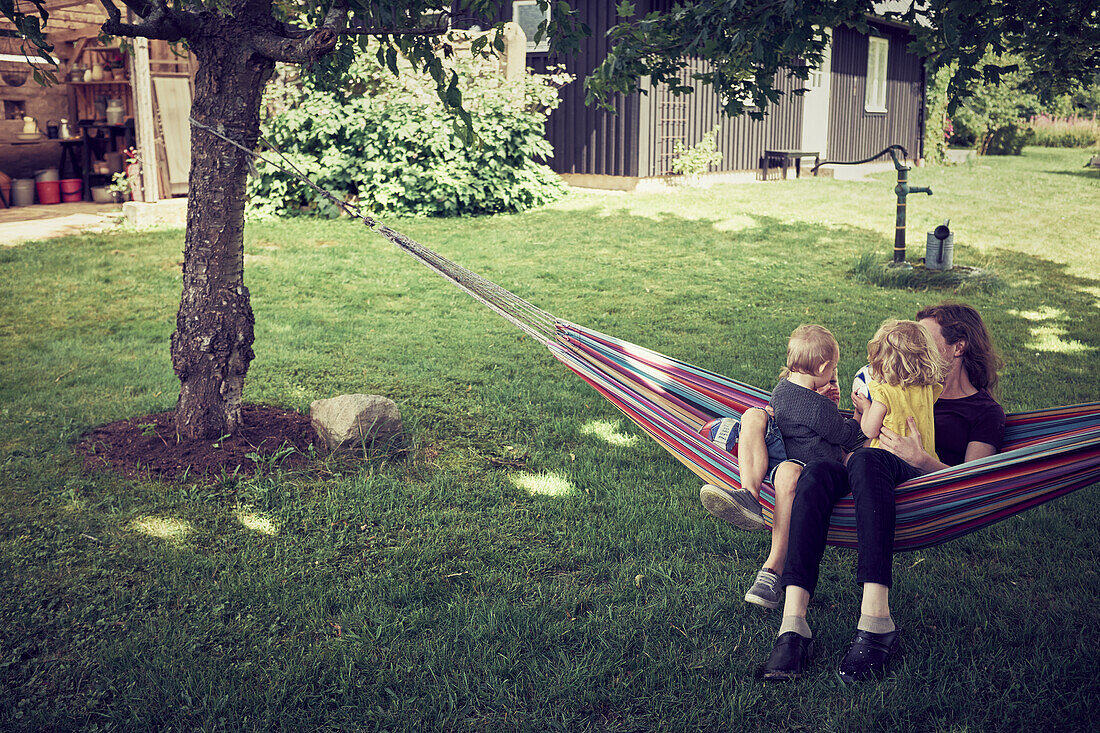 Mother with children on hammock