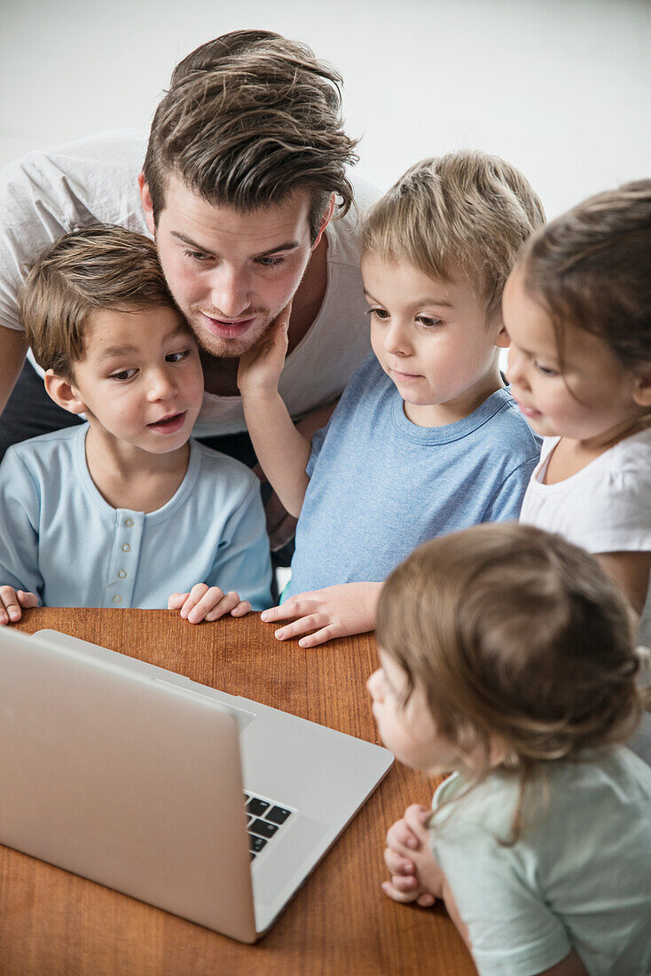 Male preschool using laptop in preschool