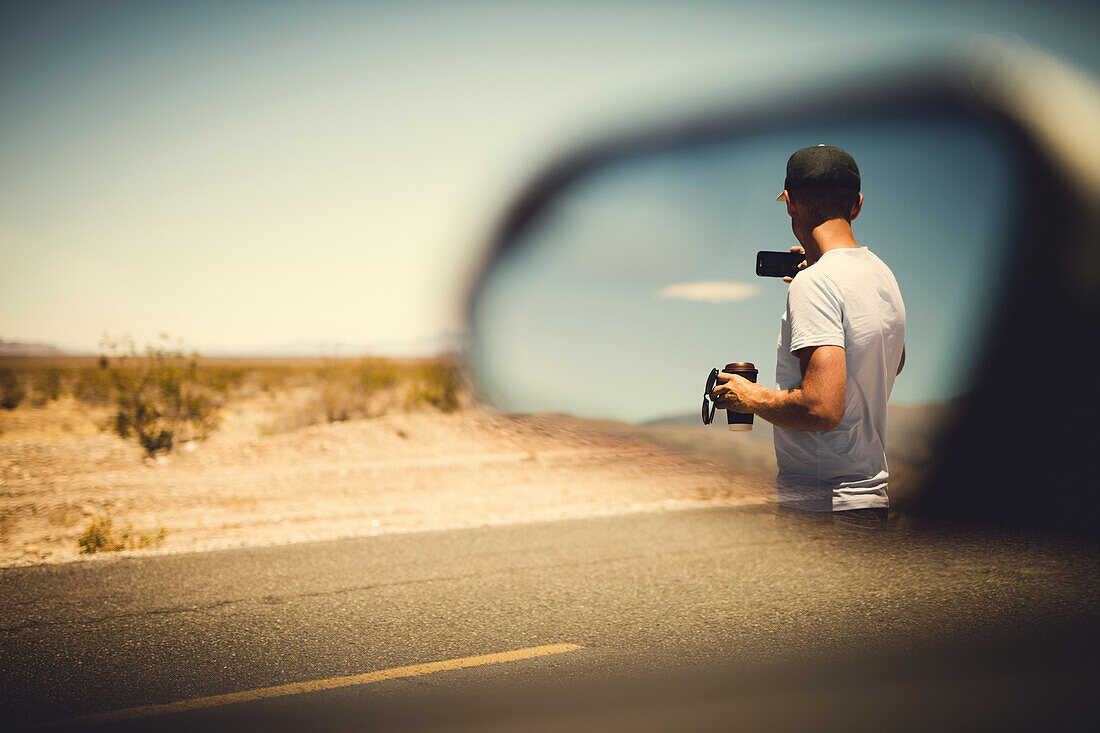 Man reflecting in side view mirror