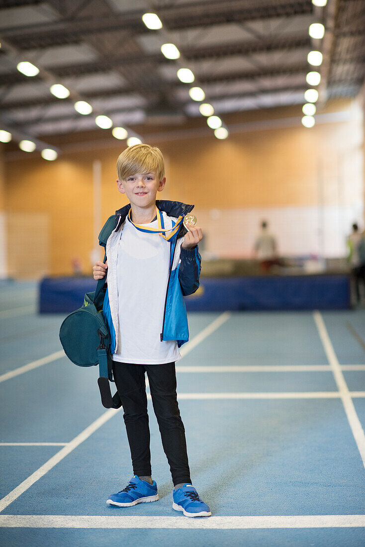 Boy showing gold medal