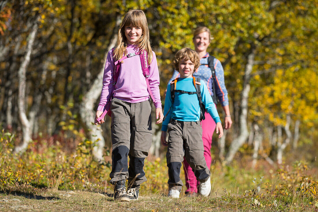 Mother hiking with children