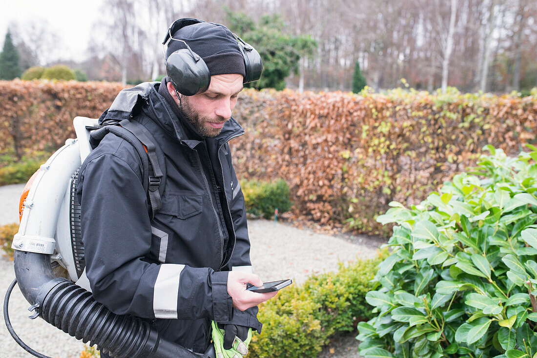 Gardener using smartphone