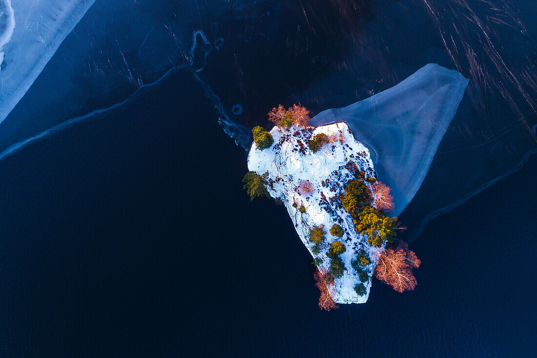 Island on frozen lake