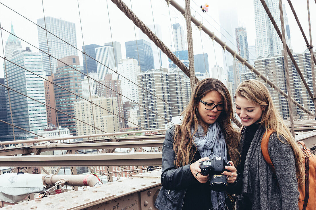 Young women looking at digital camera