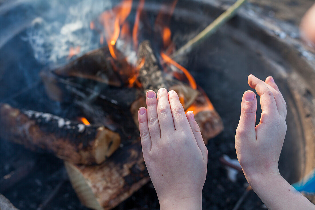 Warming hands at fire