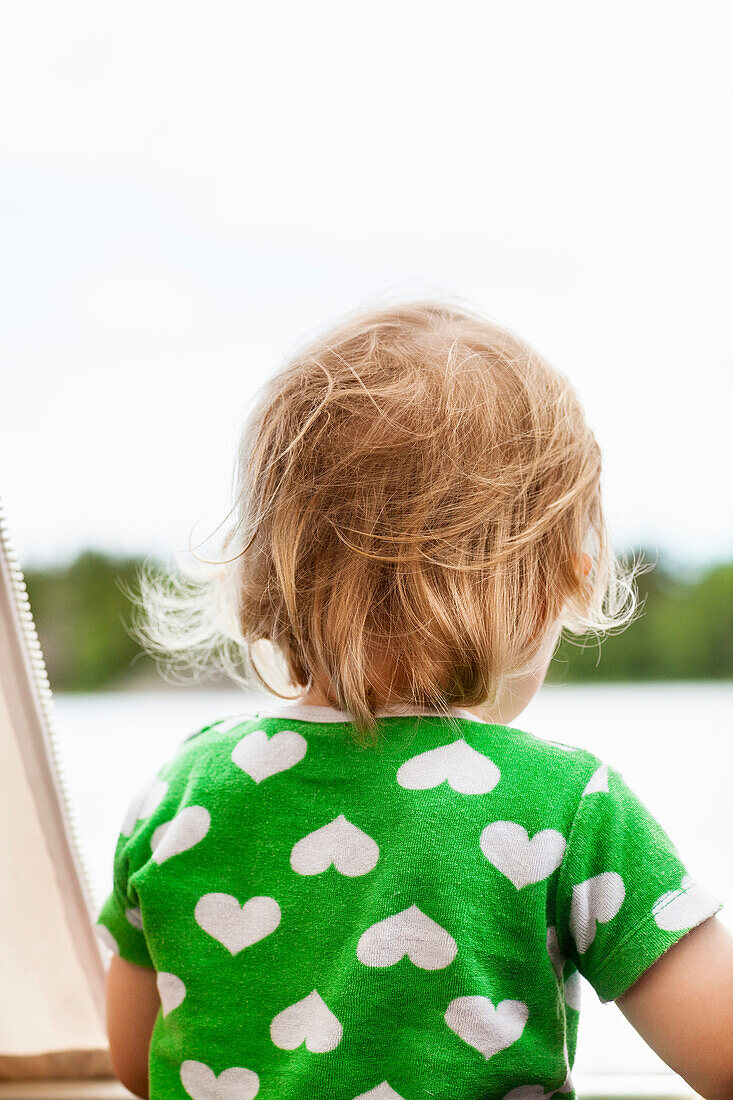 Child looking away, rear view