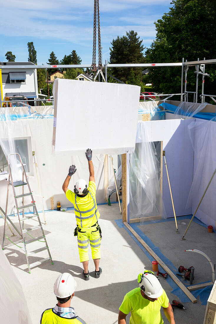 Workers building house