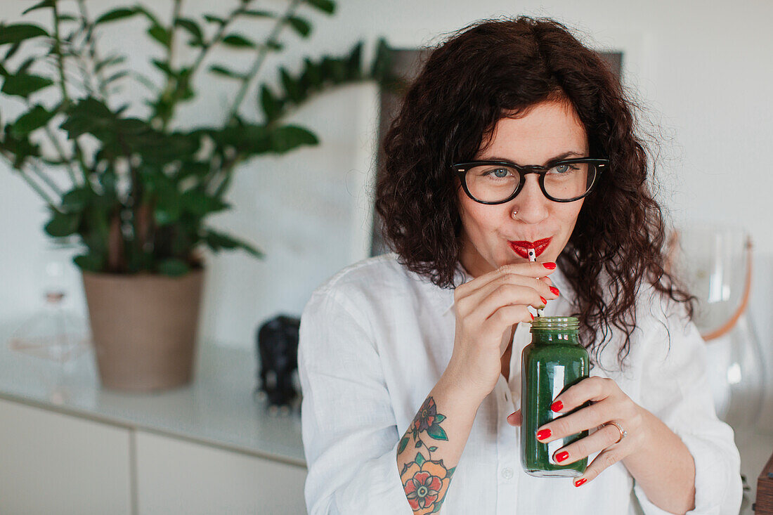 Young woman drinking smoothie