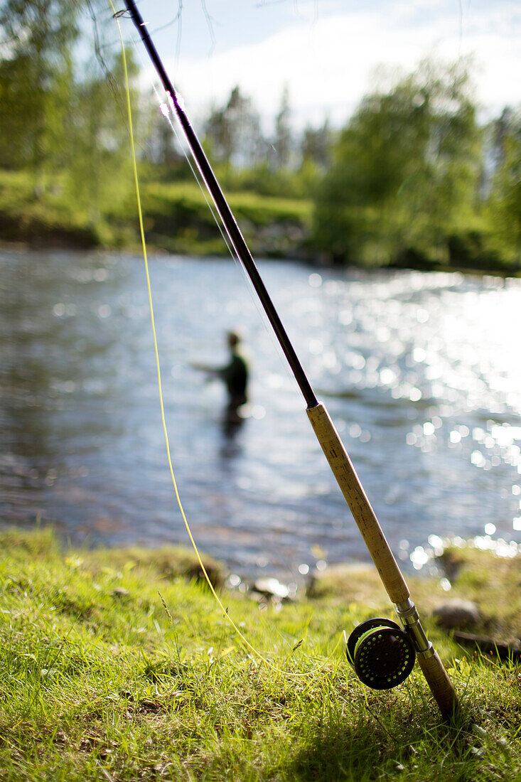 Fishing rod by river