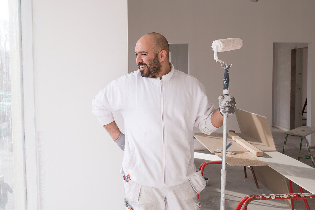 Man holding paint roller