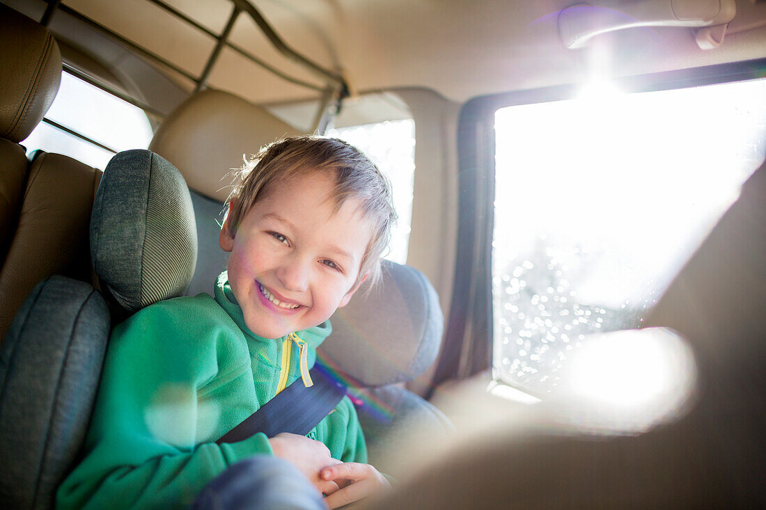 Happy boy in car