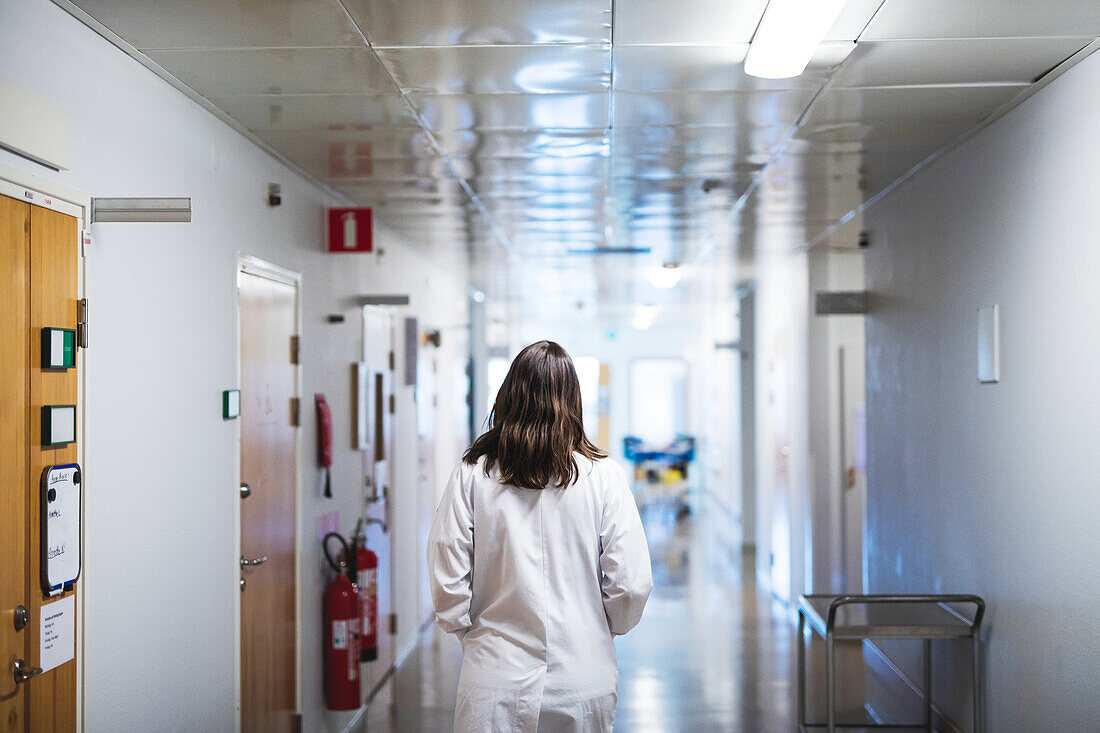 Doctor walking through hospital corridor