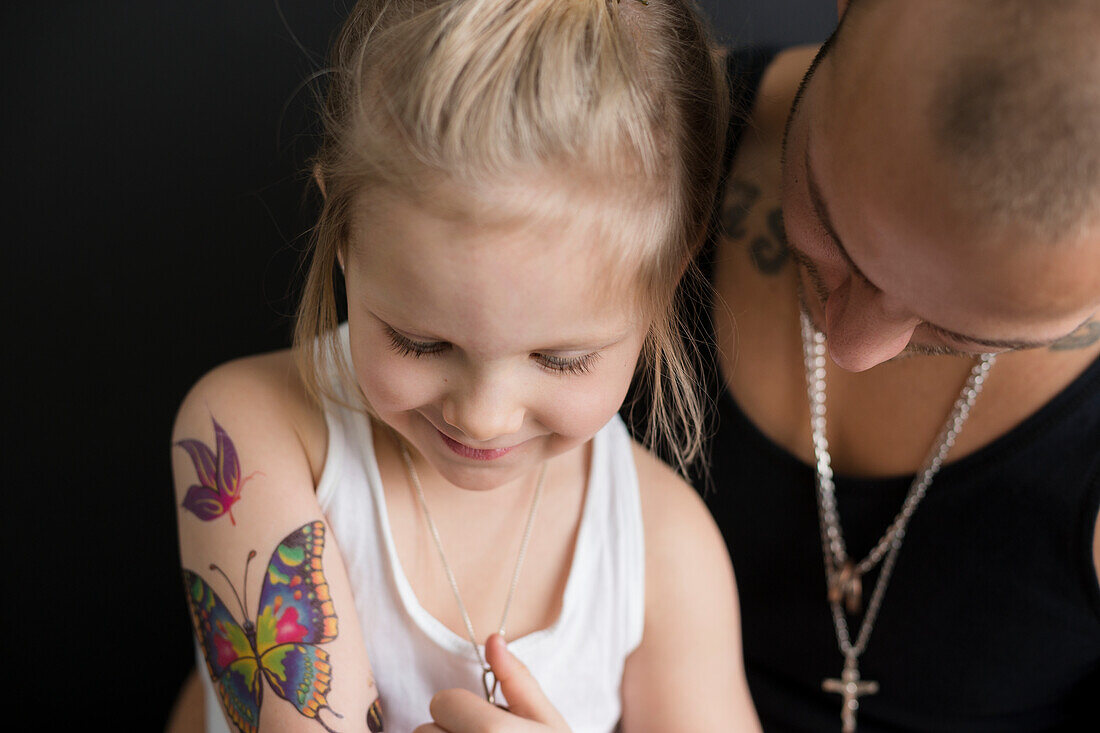 Small girl with butterfly tattoos