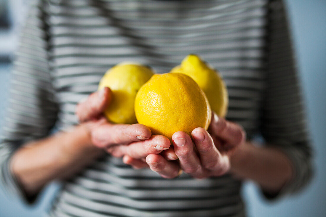 Lemons on hands