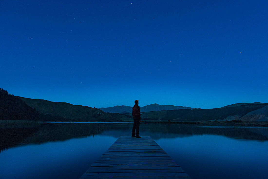 Person on jetty at night