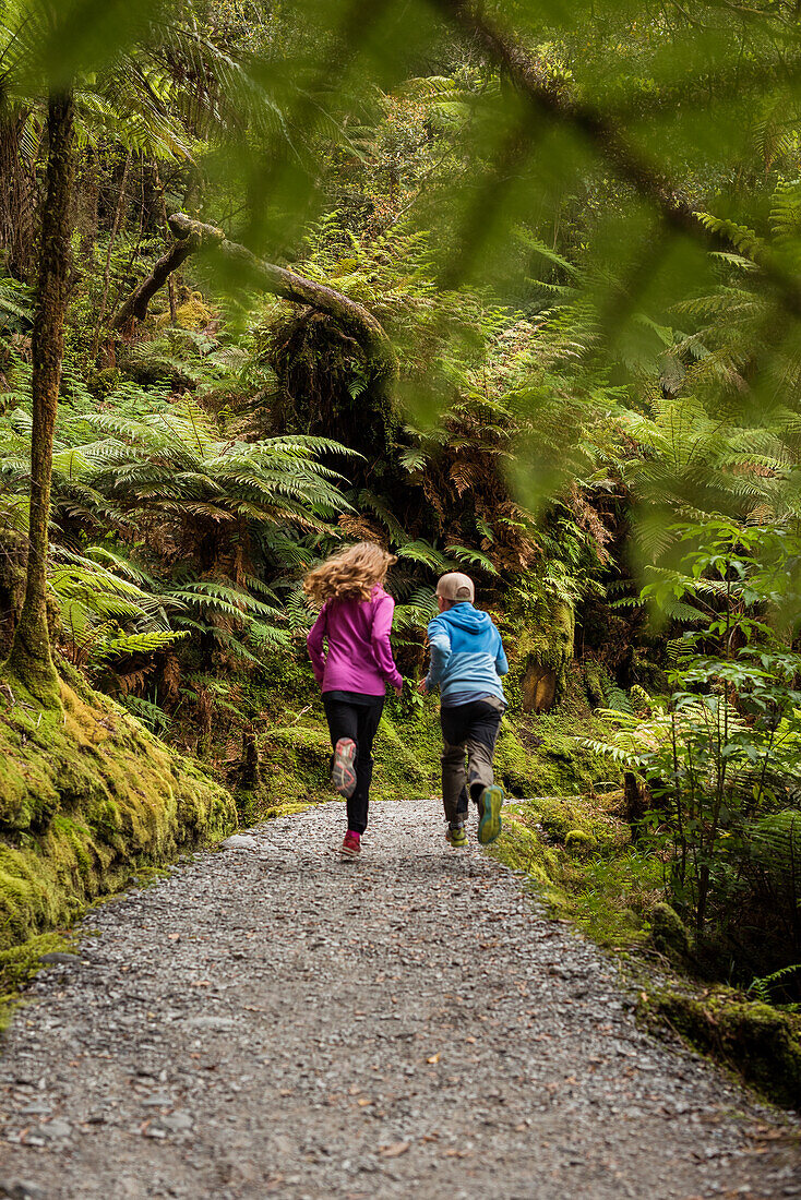 Children running through forest