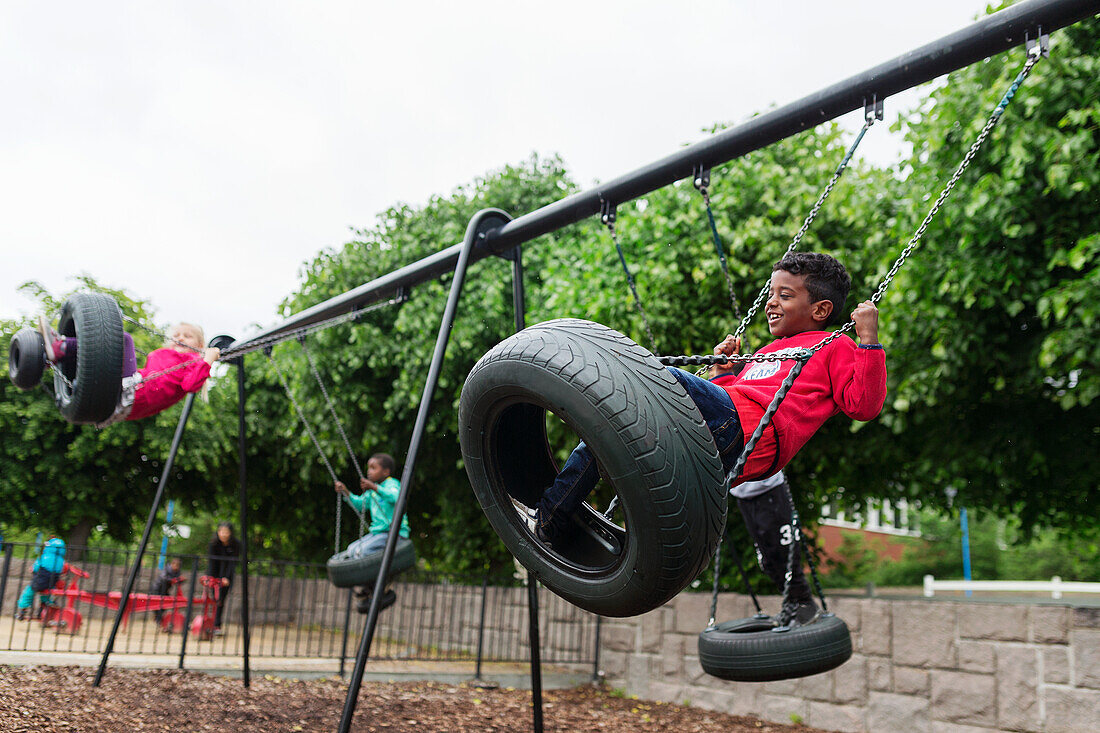 Boy swinging on tire swing