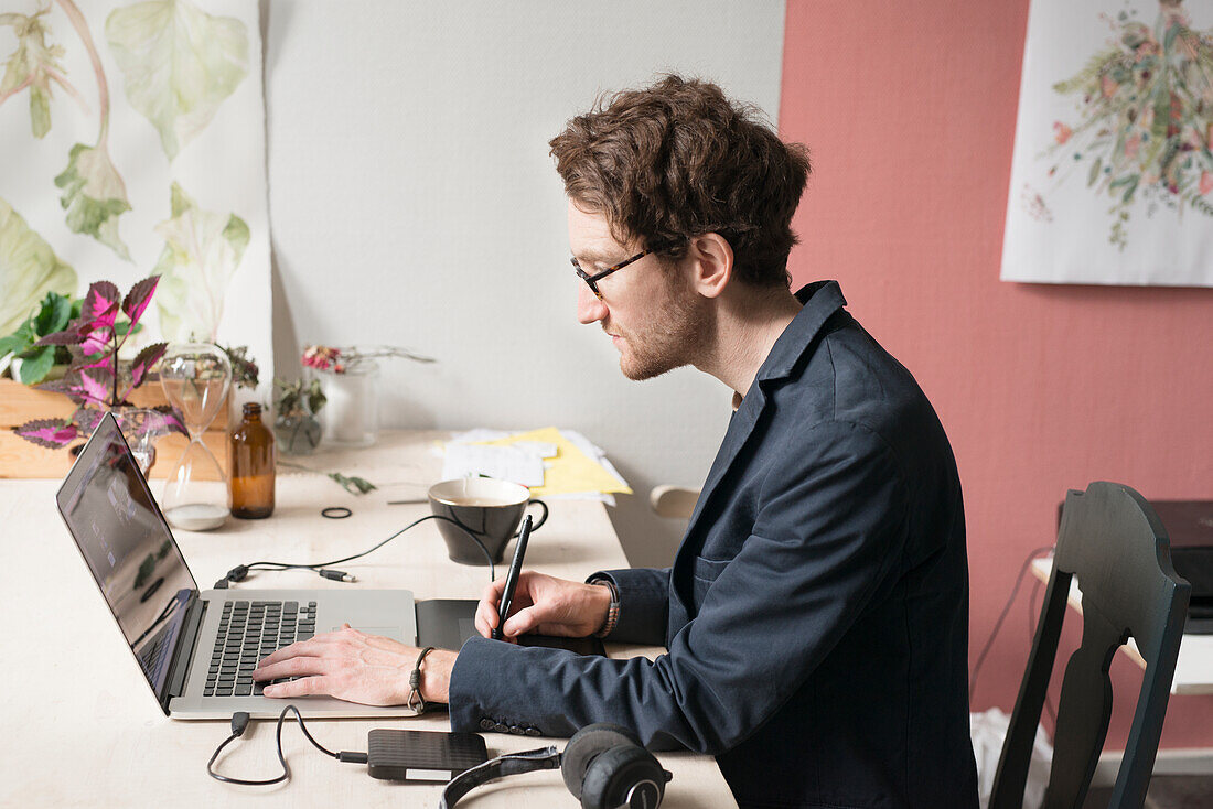 Mid adult man working on laptop