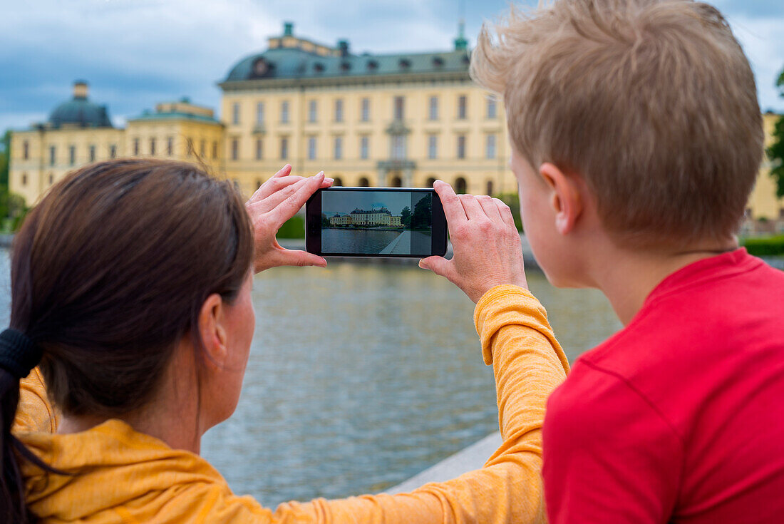 Mother and son taking photo with cell phone