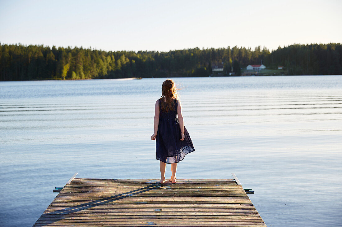 Girl standing on pier