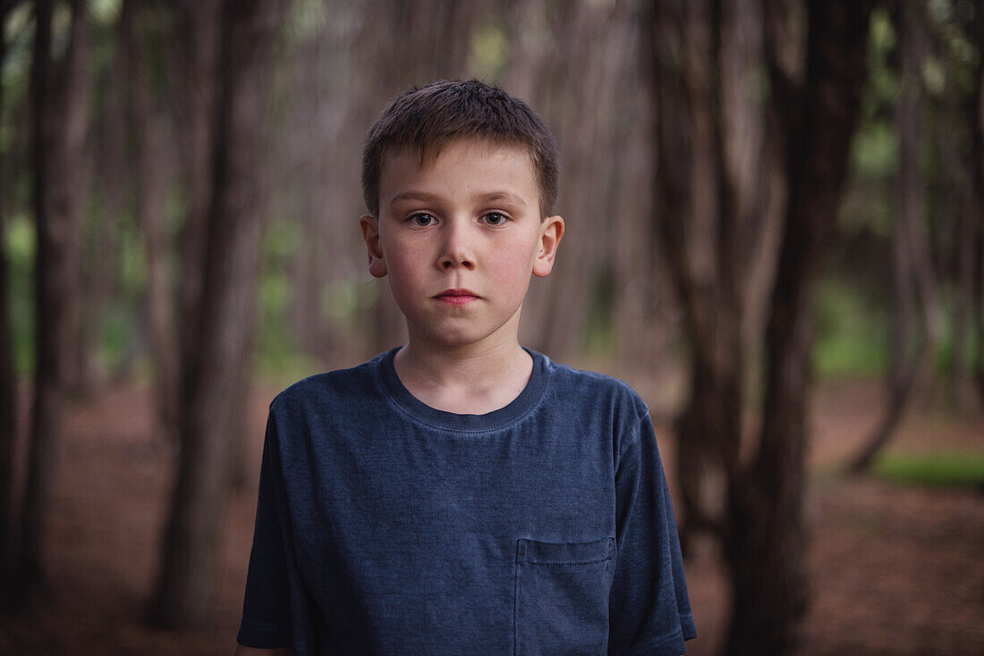 Portrait of serious boy in forest