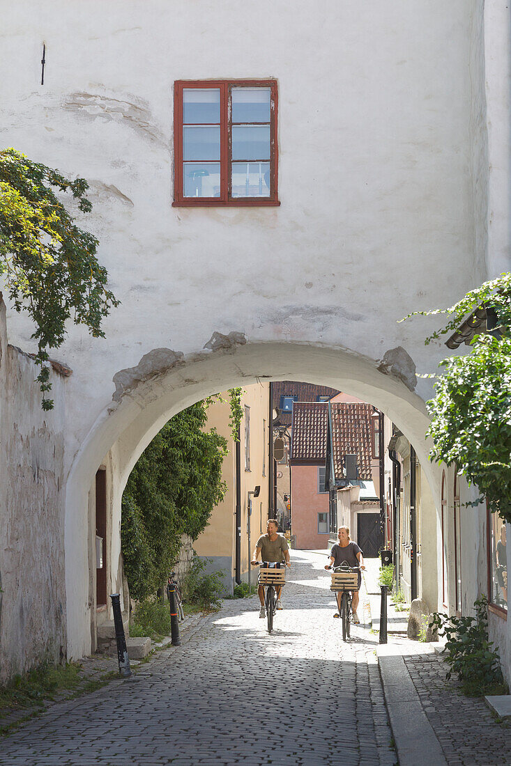 Couple cycling through old town