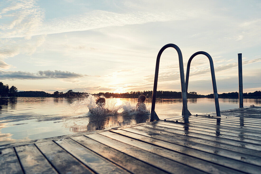 Boys swimming in lake