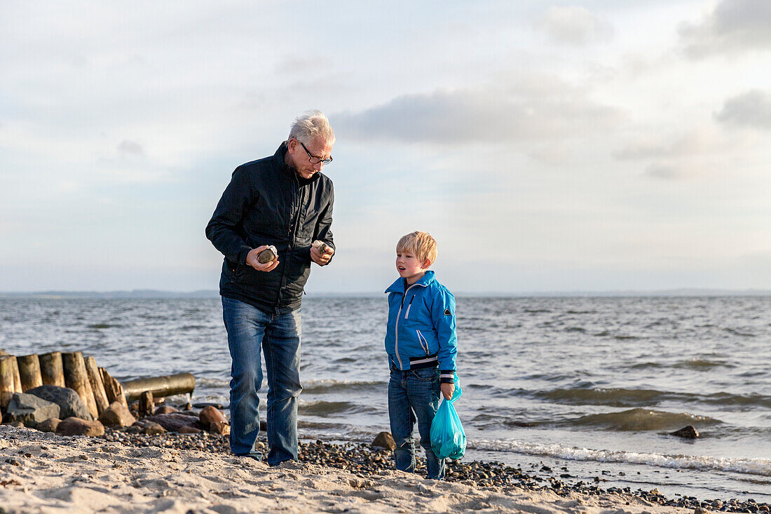 Grandfather with grandson on beach