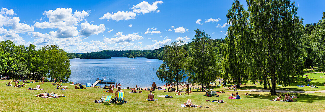 People relaxing at lake