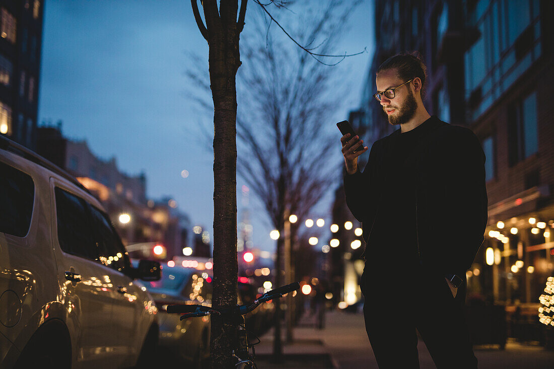 Man using phone at dusk