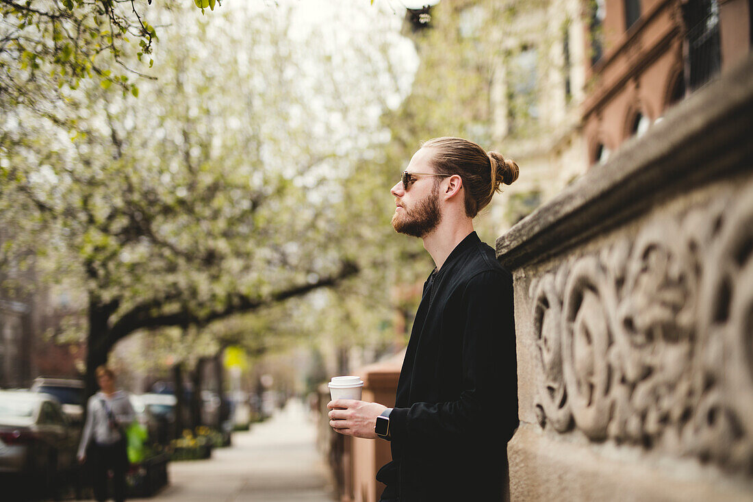 Man with take away coffee on street