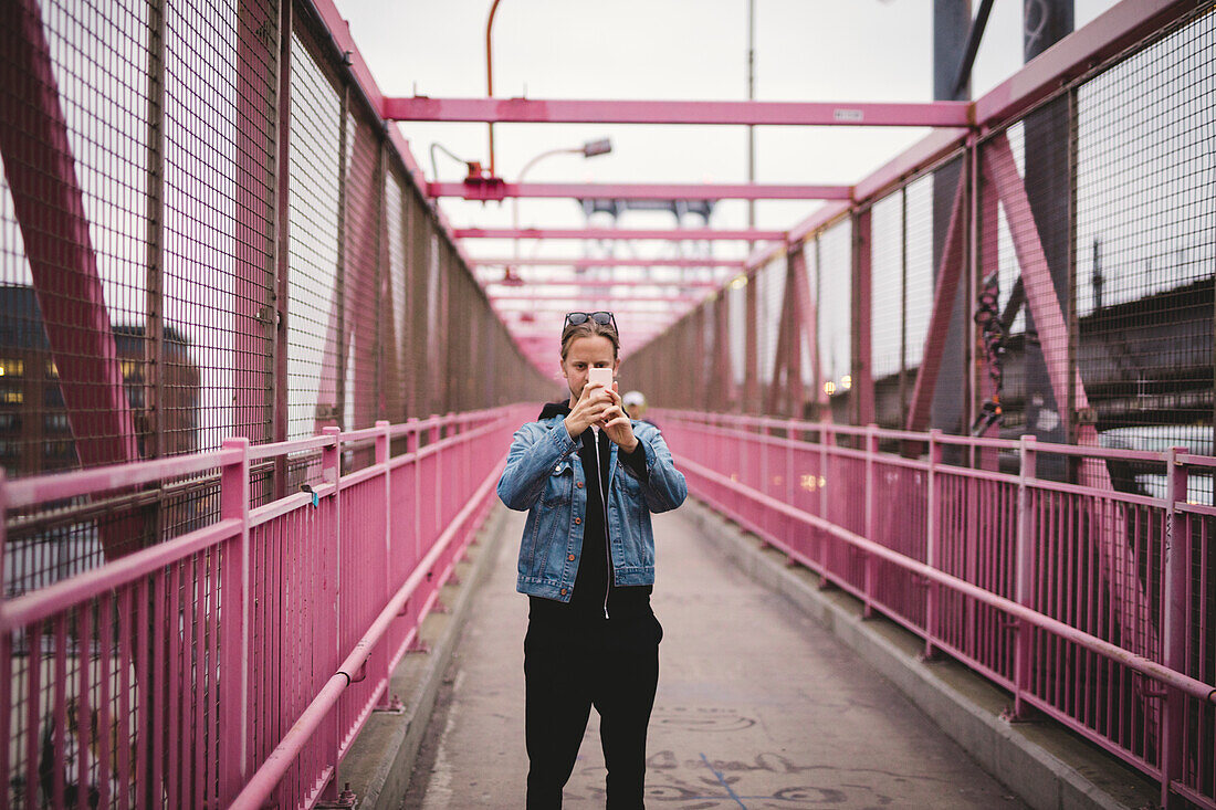 Man taking photo on bridge