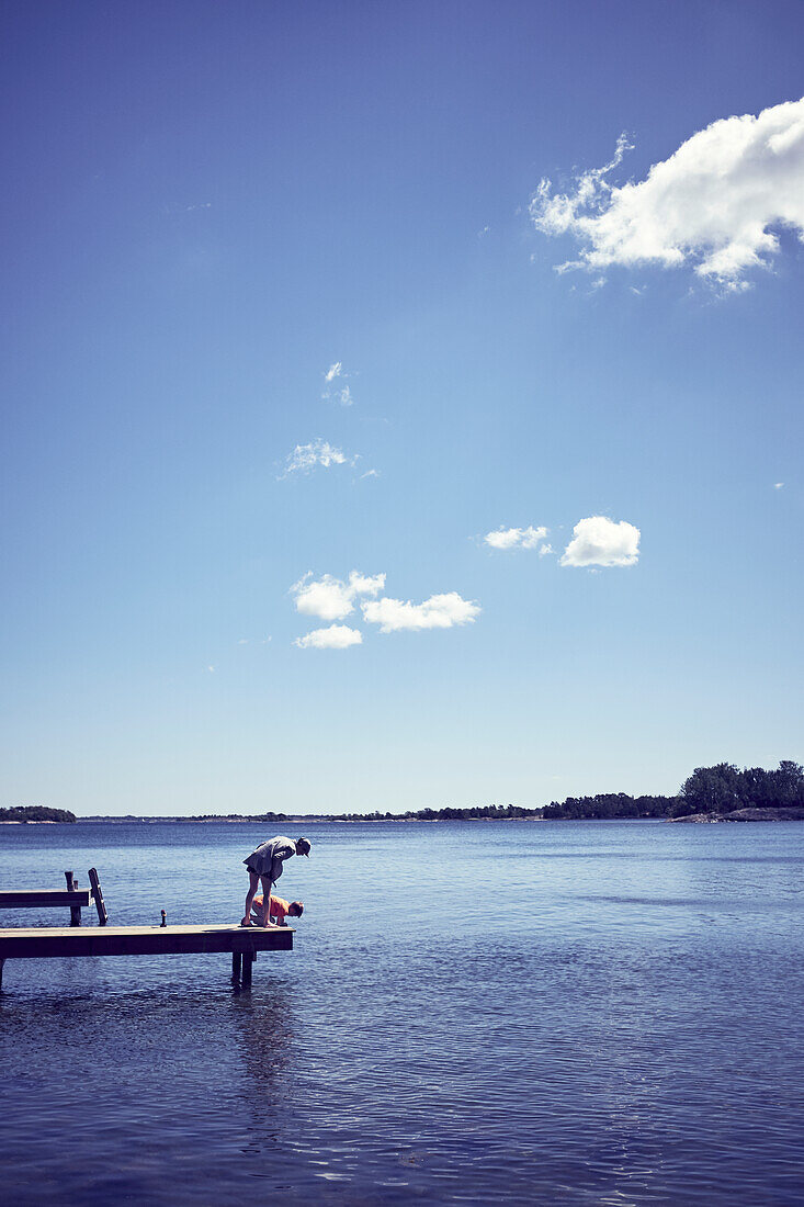 Boys relaxing on jetty