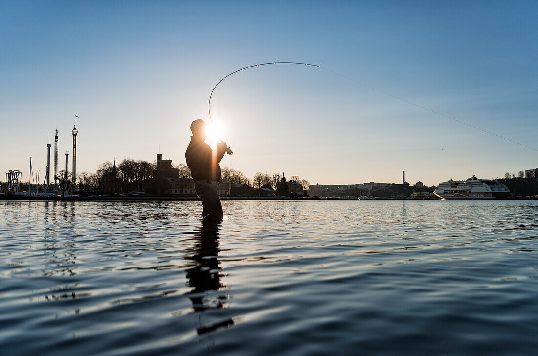 Man fishing at sunset